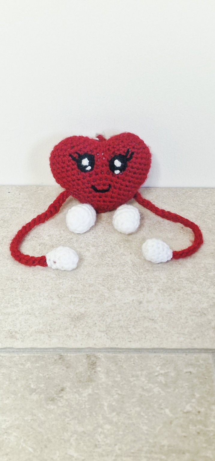 Handmade red crochet heart keychain with smiling face