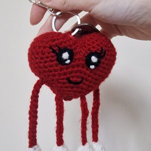 Handmade crochet heart keychain with moving arms and legs