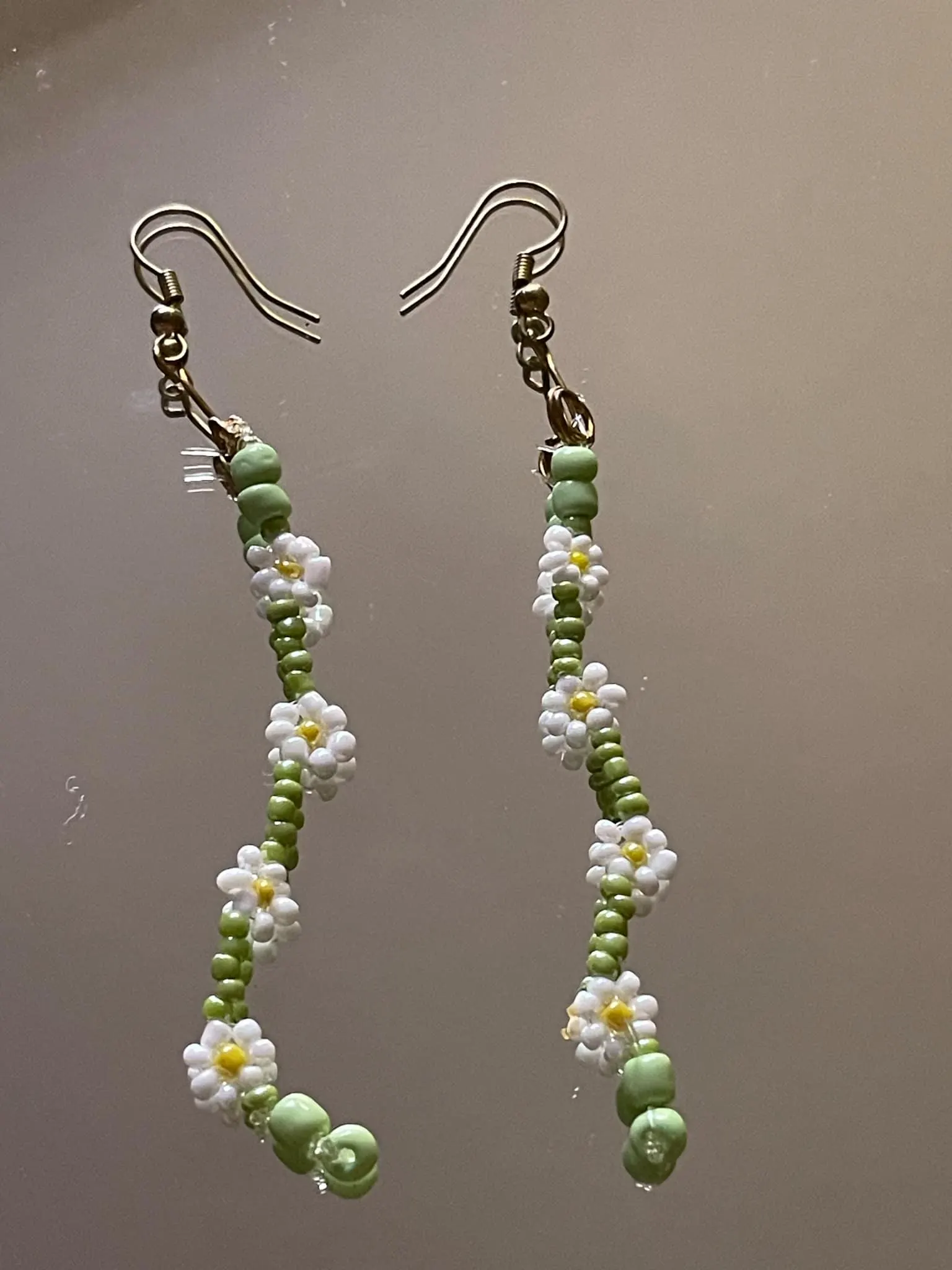 Handmade daisy beaded earrings in white and green floral design